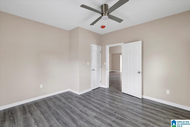 spare room with ceiling fan and dark hardwood / wood-style flooring