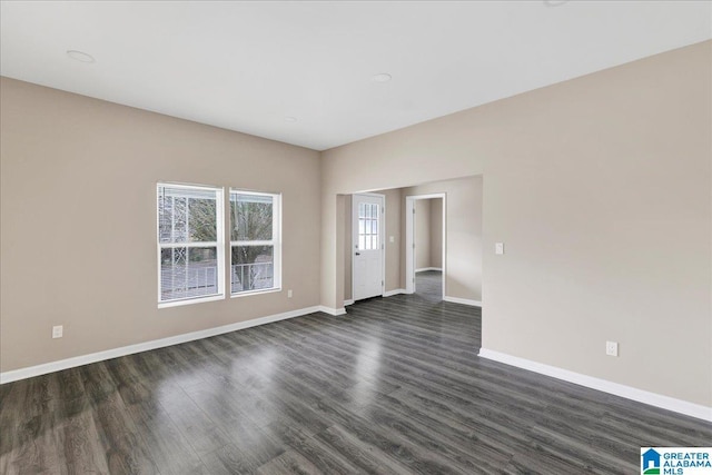 empty room with dark wood-type flooring