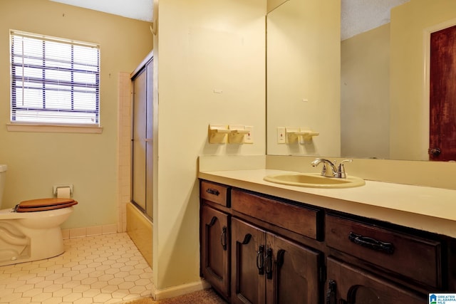 full bathroom with vanity, tile patterned flooring, combined bath / shower with glass door, and toilet