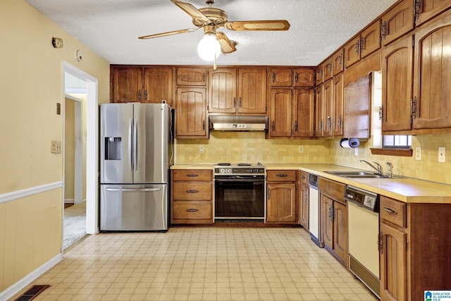 kitchen featuring sink, range, stainless steel fridge with ice dispenser, a textured ceiling, and white dishwasher