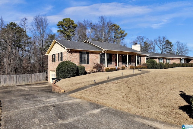 ranch-style house with a garage and covered porch