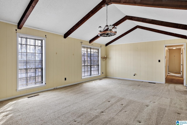 unfurnished living room featuring a notable chandelier, carpet floors, a textured ceiling, and vaulted ceiling with beams