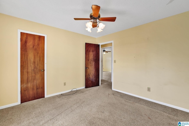 interior space featuring ceiling fan and carpet flooring