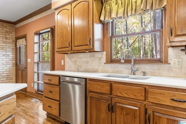 kitchen featuring light hardwood / wood-style floors, sink, decorative backsplash, and ornamental molding