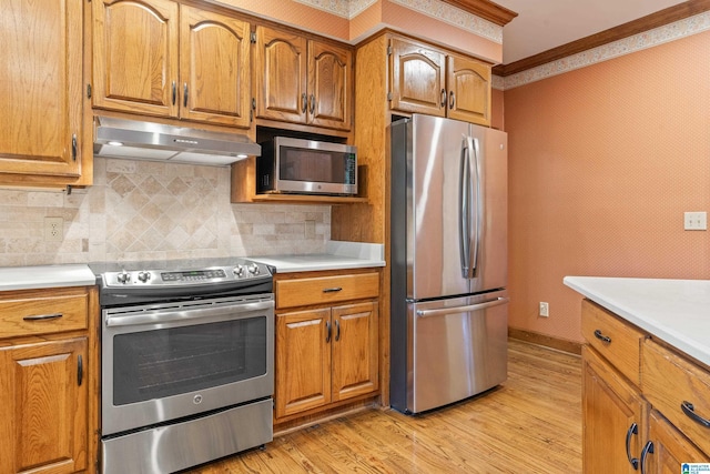 kitchen featuring ornamental molding, backsplash, light hardwood / wood-style floors, and stainless steel appliances