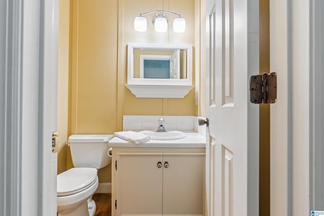 bathroom featuring toilet and vanity