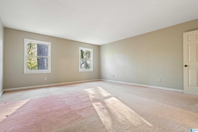 carpeted empty room featuring plenty of natural light