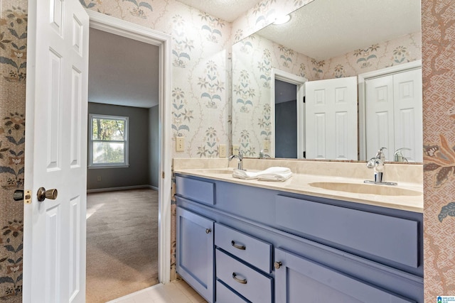 bathroom with vanity and a textured ceiling