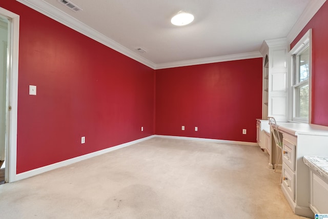 empty room with light colored carpet and ornamental molding