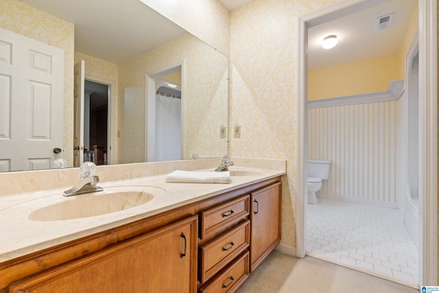 bathroom featuring vanity, toilet, and tile patterned floors