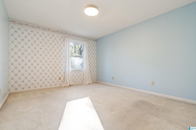 spare room with light carpet