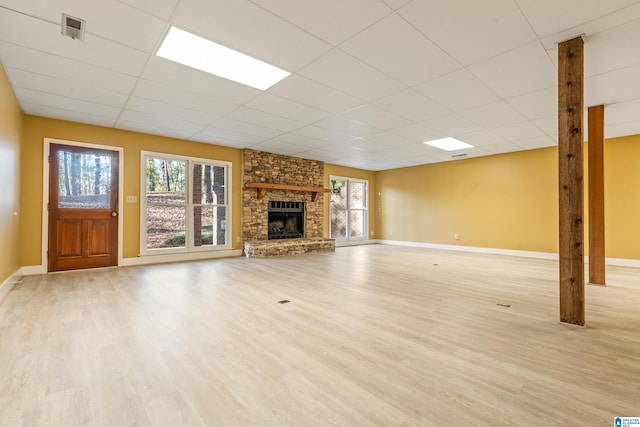 unfurnished living room featuring a fireplace and light hardwood / wood-style floors