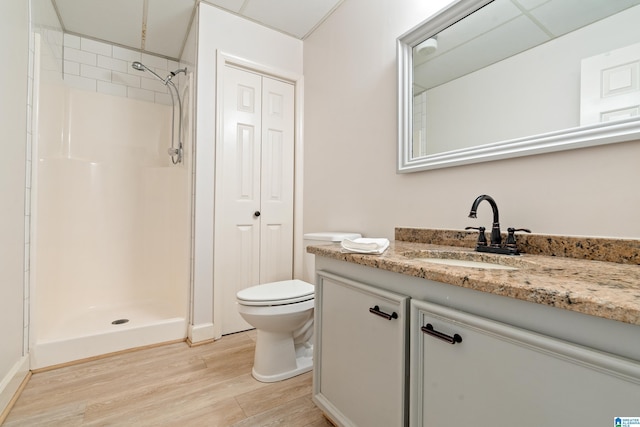 bathroom with a shower, wood-type flooring, toilet, and vanity