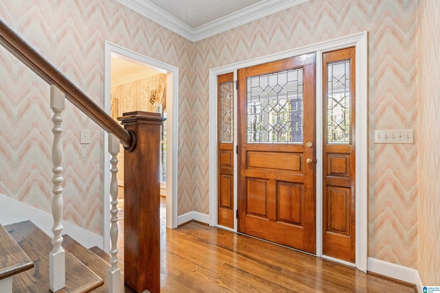 foyer featuring hardwood / wood-style flooring and ornamental molding