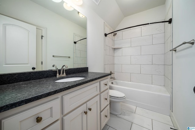 full bathroom featuring toilet, tiled shower / bath, lofted ceiling, and vanity