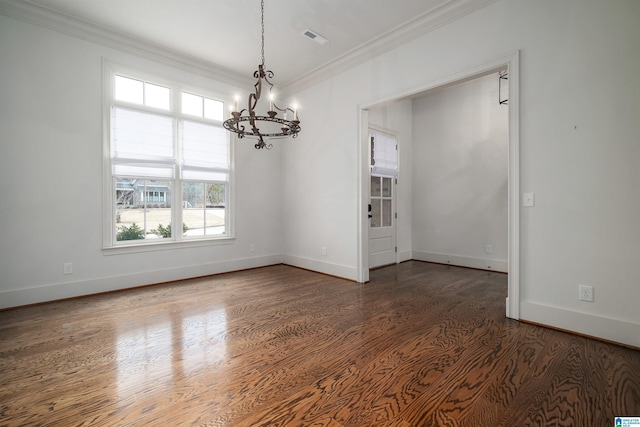 unfurnished dining area with dark wood-type flooring, an inviting chandelier, and ornamental molding