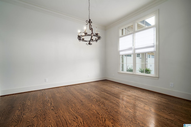 unfurnished room featuring crown molding, dark wood-type flooring, and an inviting chandelier