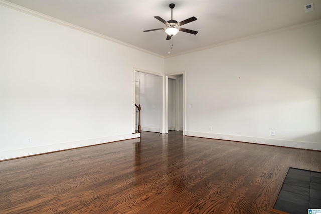 spare room with ceiling fan, dark wood-type flooring, and crown molding