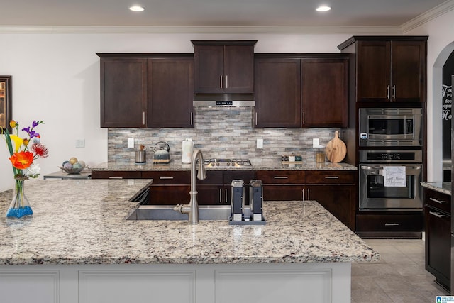 kitchen with decorative backsplash, sink, ornamental molding, and stainless steel appliances