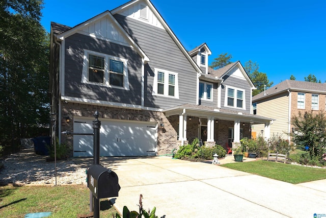 view of front of property with a garage, a front lawn, and a porch