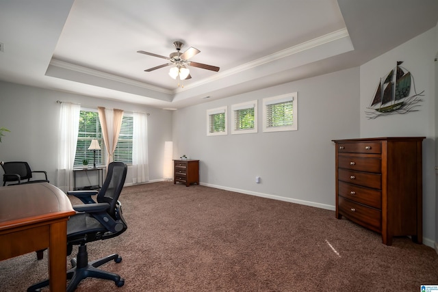 office area with crown molding, carpet floors, ceiling fan, and a raised ceiling