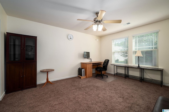 carpeted home office featuring ceiling fan