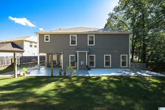 back of house with a patio area and a yard