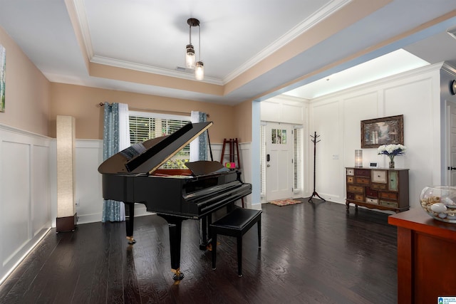 misc room featuring a tray ceiling, dark hardwood / wood-style flooring, and ornamental molding