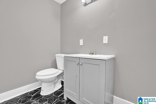 bathroom featuring toilet and vanity