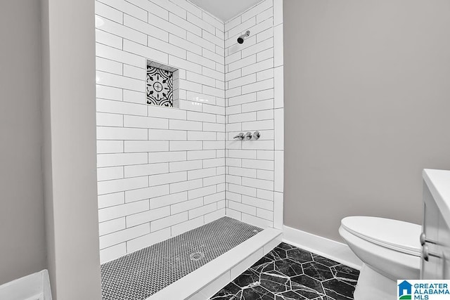 bathroom with tiled shower and toilet