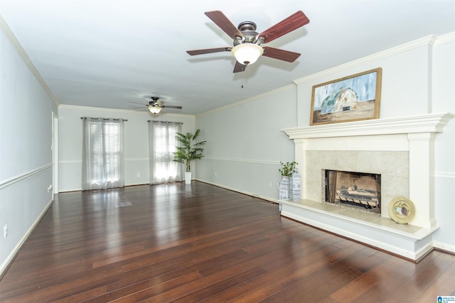 unfurnished living room featuring a tiled fireplace, dark wood-type flooring, and ornamental molding