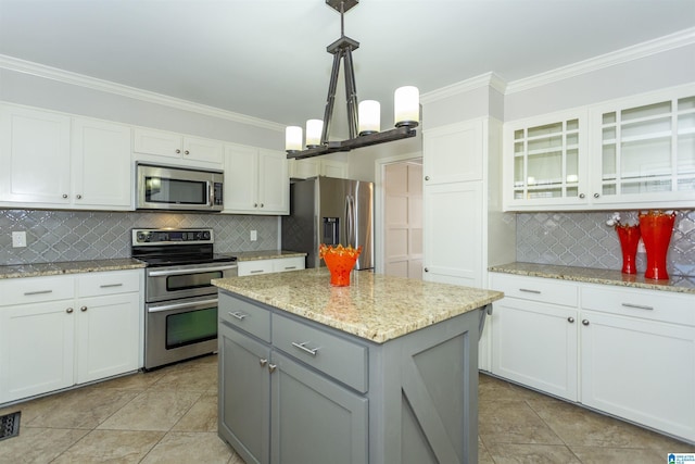 kitchen featuring tasteful backsplash, appliances with stainless steel finishes, gray cabinetry, and white cabinets