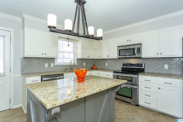 kitchen with hanging light fixtures, stainless steel appliances, sink, and a kitchen island