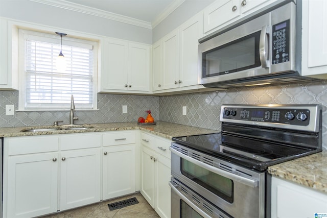 kitchen featuring sink, crown molding, white cabinetry, stainless steel appliances, and light stone countertops