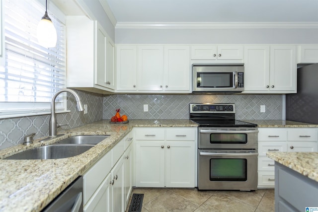 kitchen featuring sink, tasteful backsplash, hanging light fixtures, appliances with stainless steel finishes, and white cabinets