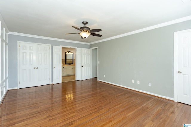 unfurnished bedroom with ceiling fan, ornamental molding, connected bathroom, and dark hardwood / wood-style flooring