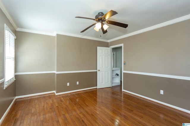 spare room with ceiling fan, ornamental molding, and wood-type flooring