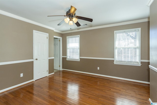 unfurnished room featuring crown molding, a healthy amount of sunlight, and hardwood / wood-style floors