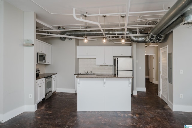 kitchen featuring a kitchen island, backsplash, white cabinets, and stainless steel appliances