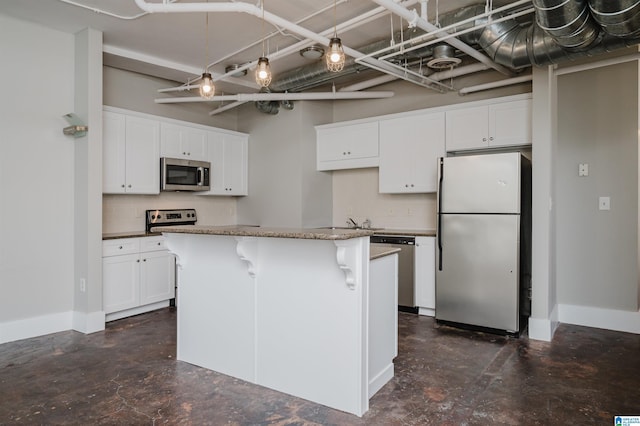 kitchen with white cabinets, stainless steel appliances, and a center island