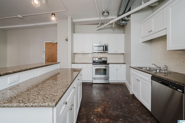 kitchen with decorative light fixtures, sink, white cabinetry, and stainless steel appliances