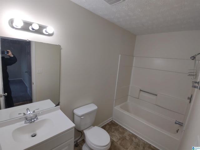 full bathroom featuring vanity,  shower combination, a textured ceiling, and toilet