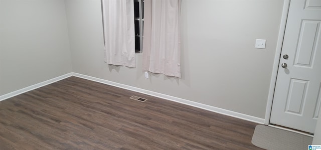 spare room with dark hardwood / wood-style flooring