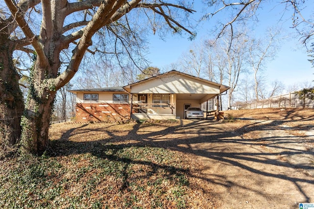 view of front of house featuring covered porch and a carport