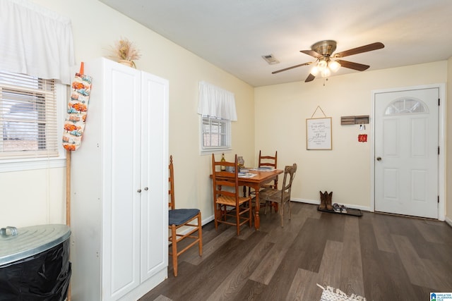 dining room with ceiling fan and dark hardwood / wood-style flooring