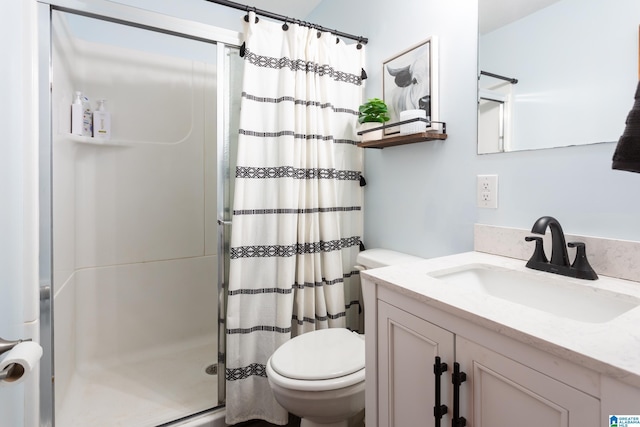 bathroom with toilet, vanity, and a shower with shower curtain