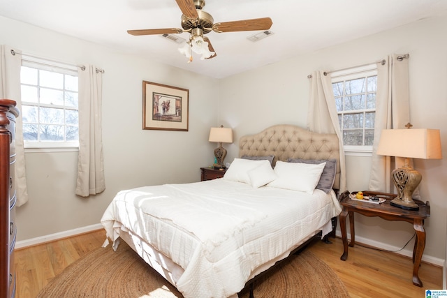 bedroom with wood-type flooring and ceiling fan