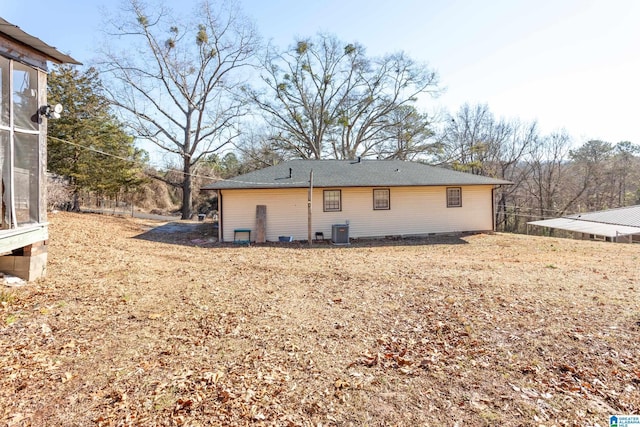 back of house with central AC unit