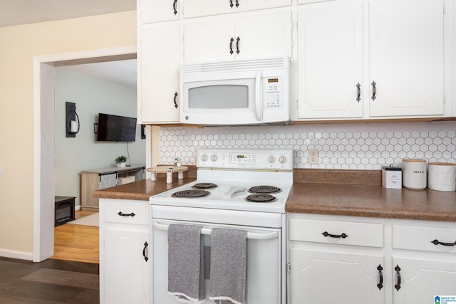 kitchen featuring white cabinets, dark hardwood / wood-style flooring, white appliances, and decorative backsplash