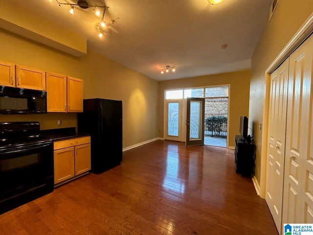 kitchen with black appliances and dark wood-type flooring